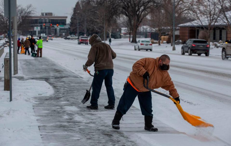 Workers from Columbia Industries clear the sidewalks outside of the Richland Federal Building and U.S. Courthouse along Jadwin Avenue on Monday morning.