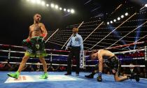 Vasiliy Lomachenko knocks down José Pedraza during the 11th round of their lightweight title unification fight on Saturday in New York.