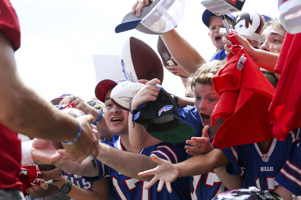 Fans react as Buffalo Bills quarterback Josh Allen (17) signs autographs after practice at the NFL football team's training camp in Pittsford, N.Y., Monday July 25, 2022. (AP Photo/Joshua Bessex)