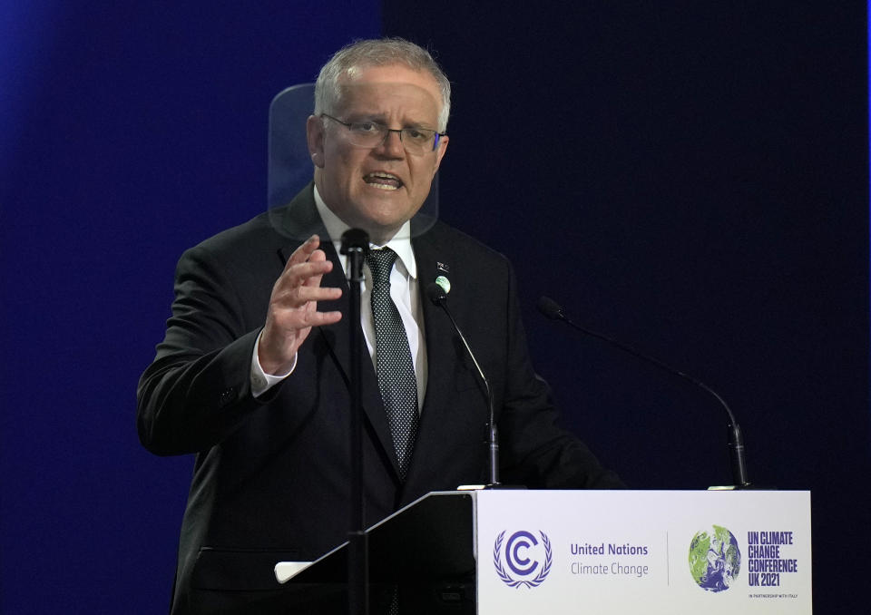 FILE - Australian Prime Minister Scott Morrison gestures as he makes a statement at the COP26 U.N. Climate Summit in Glasgow, Scotland, Nov. 1, 2021. The U.S., Britain and a handful of others aren’t sending dignitaries to the Beijing Games as part of a diplomatic boycott, but the Chinese capital is still attracting an array of world leaders for the opening ceremony on Friday, Feb. 4. Morrison said the move was “in Australia’s national interest.” (AP Photo/Alastair Grant, Pool, File)