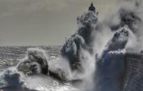 Waves crash against Tynemouth Lighthouse on the north-east coast