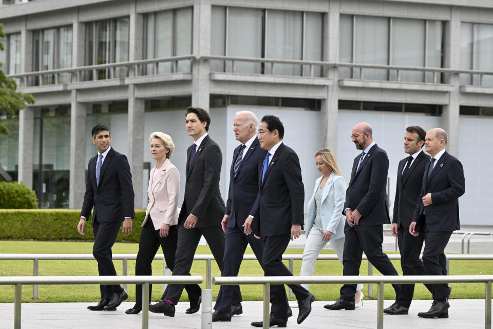 From left, British Prime Minister Rishi Sunak, European Commission President Ursula von der Leyen, Canadian Prime Minister Justin Trudeau, U.S. President Joe Biden, Japan's Prime Minister Fumio Kishida, Italian Premier Giorgia Meloni, European Council President Charles Michel, French President Emmanuel Macron and German Chancellor Olaf Scholz walk to get into place to participate in a wreath laying ceremony at the Peace Memorial Park as part of the G7 Hiroshima Summit in Hiroshima, western Japan Friday, May 19, 2023. (Kenny Holston/Pool Photo via AP)