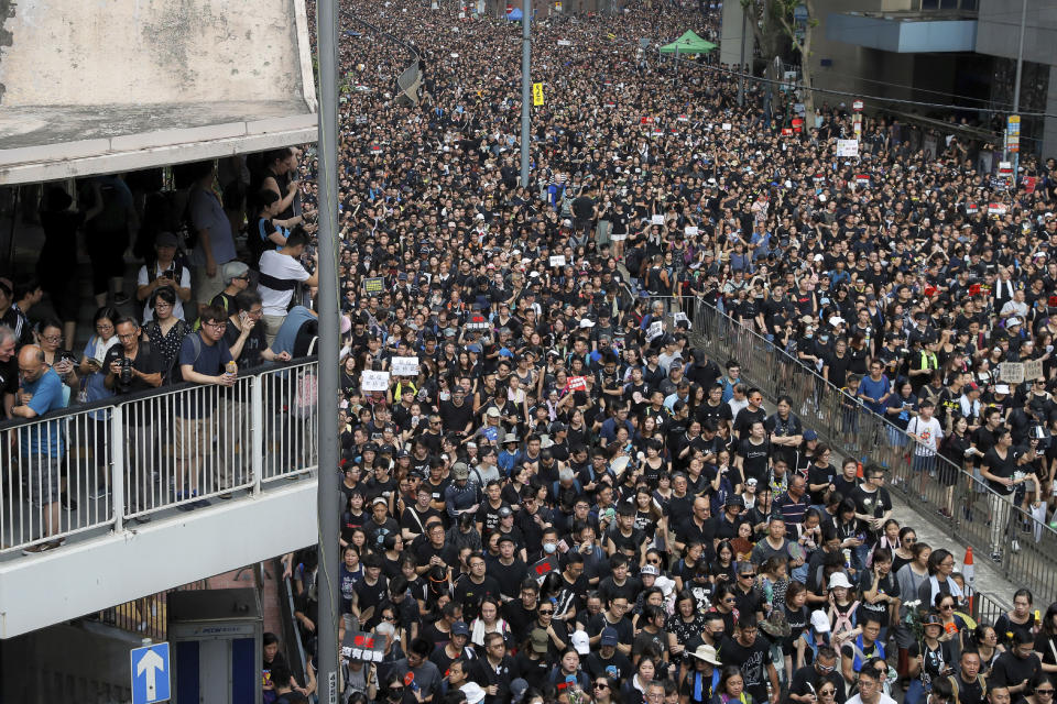 In this Sunday, June 16, 2019, photo, tens of thousands of protesters march on a street to protest against the unpopular extradition bill in Hong Kong. All but a handful of protesters in Hong Kong have gone home, but the crisis that brought nearly 2 million into the streets to oppose an extradition bill is far from over. (AP Photo/Kin Cheung)