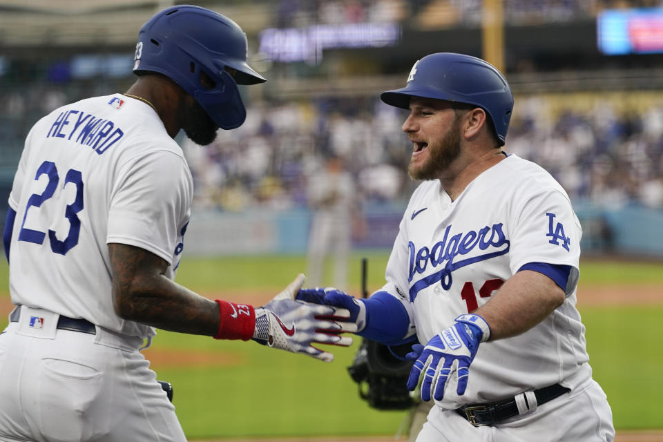 Los Angeles Dodgers' Max Muncy (13) celebrates with Jason Heyward (23) after hitting a home run during the first inning of a baseball game against the Minnesota Twins in Los Angeles, Monday, May 15, 2023. (AP Photo/Ashley Landis)