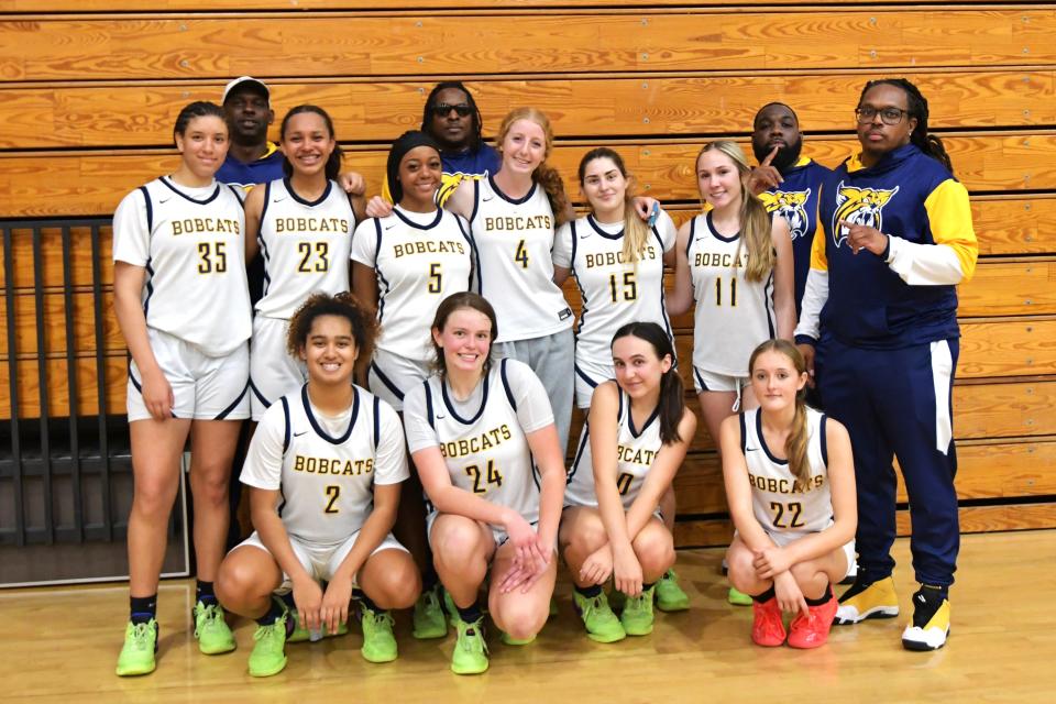 Tatyana Campise-Pinkney (2) and the Boca Raton Varsity girls basketball team pose after their winning the regional semifinal playoff game against Miami on Feb. 19, 2024.