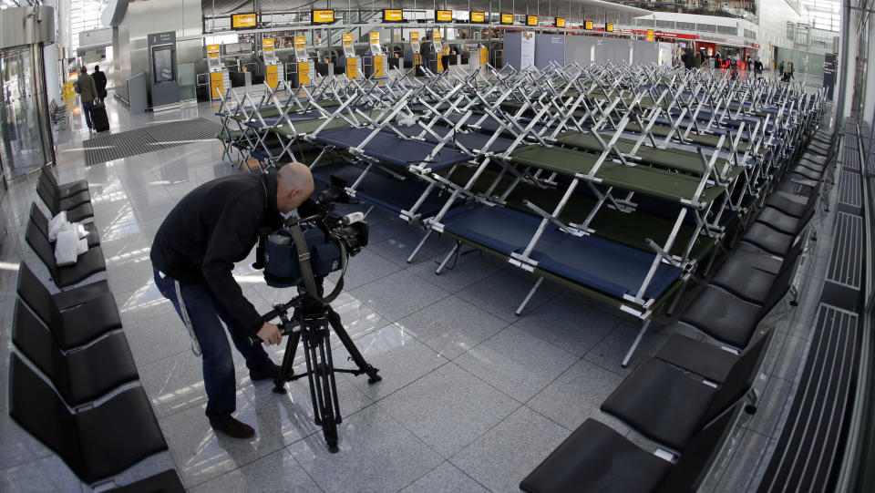 A camera man films beds for stranded passengers as flight attendants of German Lufthansa airline went on a 24-hour-strike for higher wages at the airport in Munich, southern Germany, on Friday, Sept. 7, 2012. (AP Photo/Matthias Schrader)