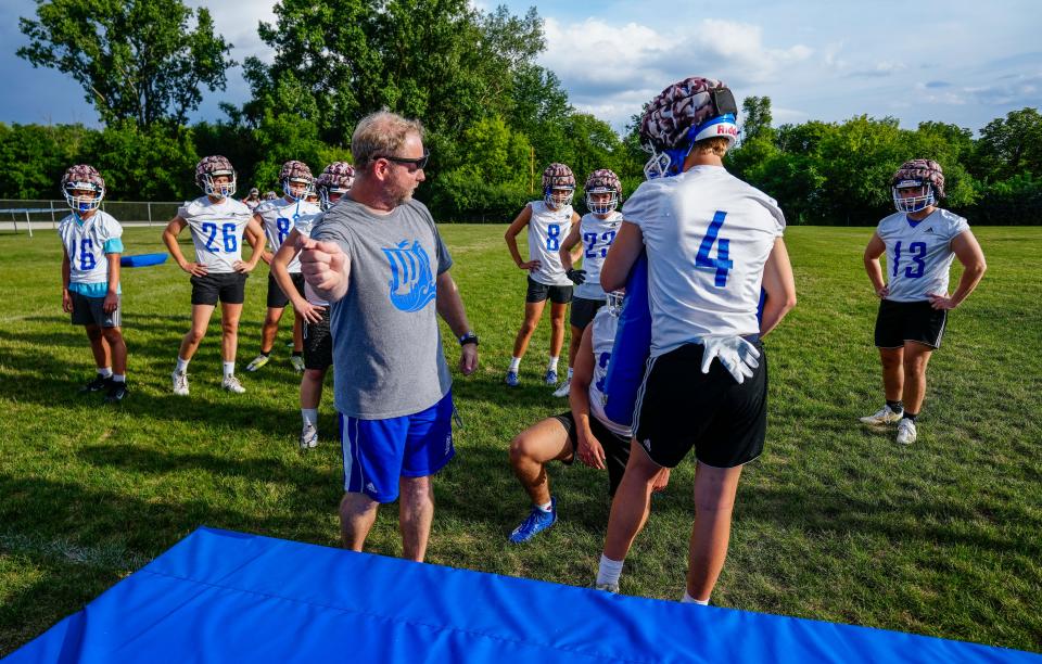 New Berlin West coach Ben Chossek works with players during the first day of practice.