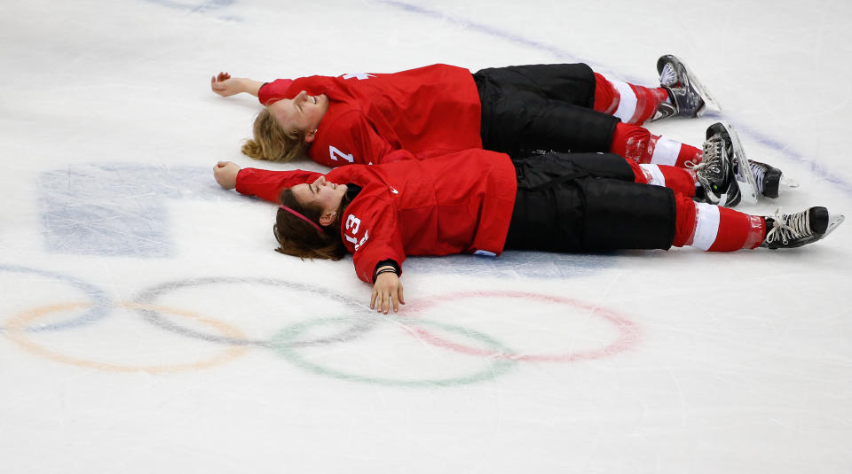 Sara Benz of Switzerland (13) and Lara Stalder of Switzerland (7) celebrate their 4-3 win over Sweden in the women's bronze medal ice hockey game at the 2014 Winter Olympics, Thursday, Feb. 20, 2014, in Sochi, Russia. (AP Photo/Petr David Josek)