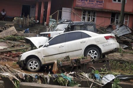 Vehicles damaged by the flood waters are pictured at Goalpara district, after heavy rains in Assam September 23, 2014. REUTERS/Stringer