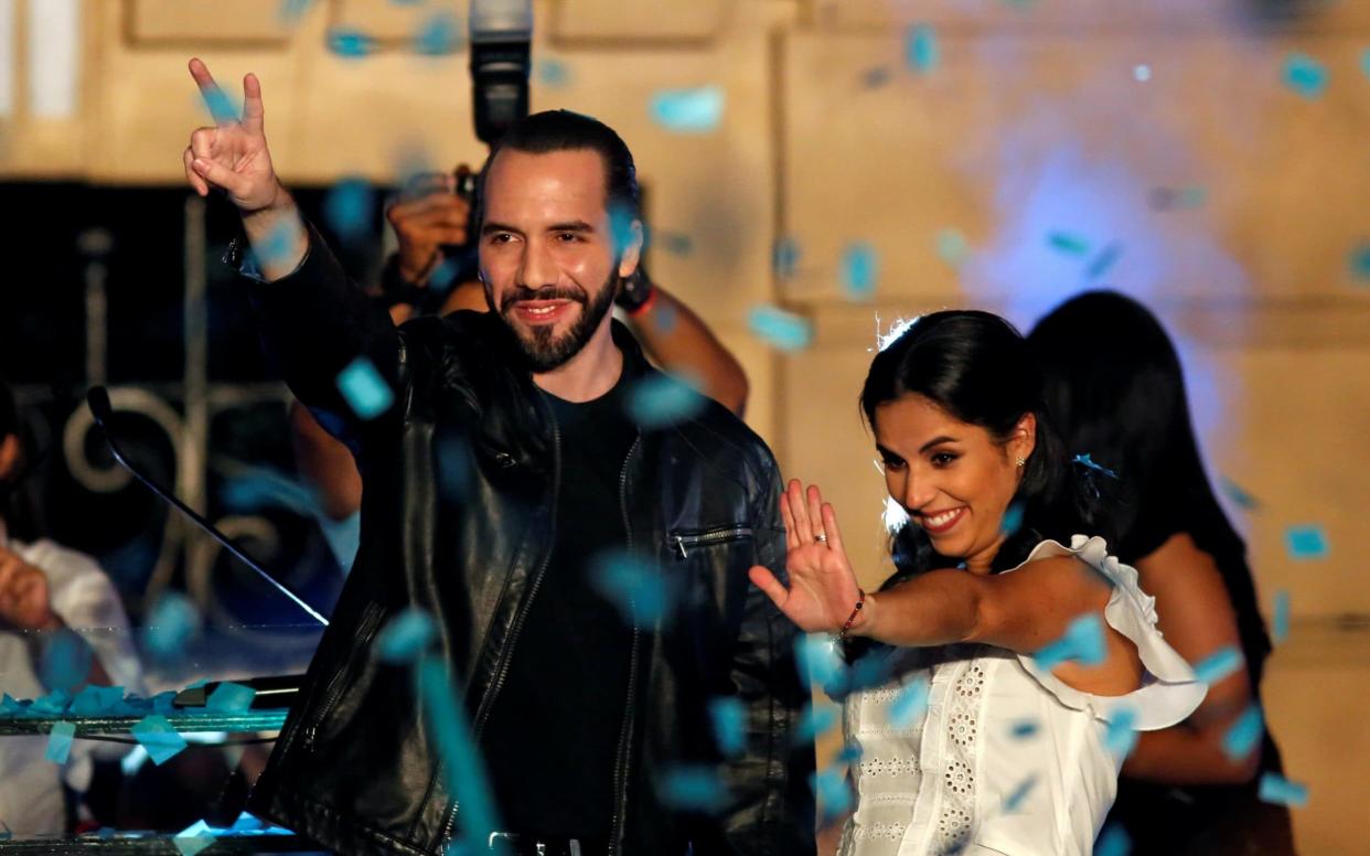 Presidential candidate Nayib Bukele of the Great National Alliance (GANA) and his wife Gabriela de Bukele gesture as they celebrate with supporters - REUTERS
