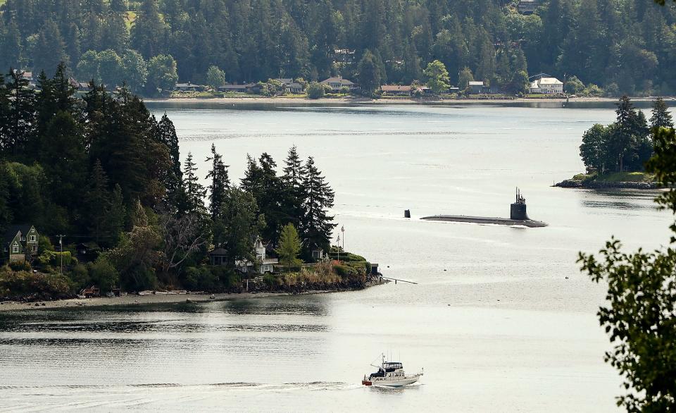 The USS Connecticut (SSN-22), a Seawolf-class nuclear-powered fast attack submarine, transits Rich Passage as it heads for Naval Base Kitsap-Bremerton in May 2021.