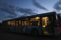 Ukrainian servicemen sit in a bus after they were evacuated from the besieged Mariupol's Azovstal steel plant, near a prison in Olyonivka, in territory under the government of the Donetsk People's Republic, eastern Ukraine, Tuesday, May 17, 2022. More than 260 fighters, some severely wounded, were pulled from a steel plant on Monday that is the last redoubt of Ukrainian fighters in the city and transported to two towns controlled by separatists, officials on both sides said. (AP Photo)