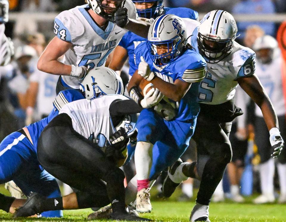 Marian’s Brian Osman (21) carries in the fourth quarter against St. Joseph Friday, Oct. 14, 2022, at Otolski Field.