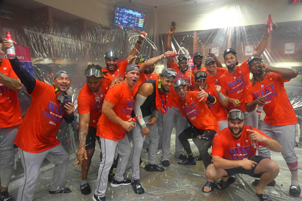 Astros players celebrate after clinching the AL West on Sunday.