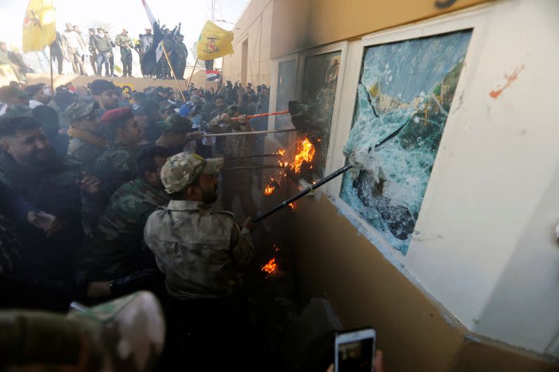 Protesters and militia fighters attack a reception room of the U.S. Embassy in Baghdad