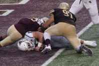 Coastal Carolina's Baden Pinson (31) falls into the end zone for a touchdown against Texas State's Emmanuel Galvan-Vazquez (97) and Brendon Luper (25) during the second half of an NCAA college football game in San Marcos, Texas, Saturday, Nov. 28, 2020. (AP Photo/Chuck Burton)