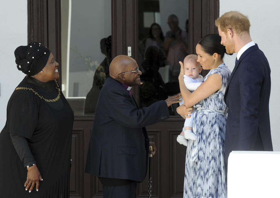 FILE - In this Wednesday, Sept. 25, 2019 file photo, Britain's Prince Harry and Meghan, Duchess of Sussex, holding their son Archie, meet Anglican Archbishop Emeritus, Desmond Tutu and his wife Leah in Cape Town, South Africa. Prince Harry and his wife, Meghan, are fulfilling their last royal commitment Monday March 9, 2020 when they appear at the annual Commonwealth Service at Westminster Abbey. It is the last time they will be seen at work with the entire Windsor clan before they fly off into self-imposed exile in North America. (Henk Kruger/Pool via AP, File)
