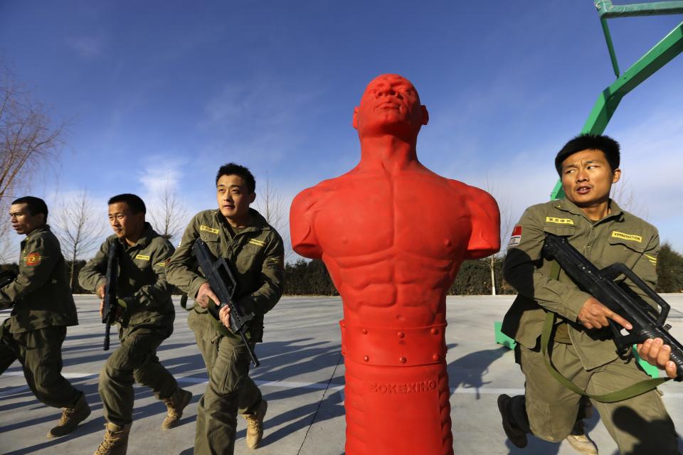 Trainees hold replica 95 semi-automatic rifles as they take part in Tianjiao Special Guard/Security Consultant training on the outskirts of Beijing