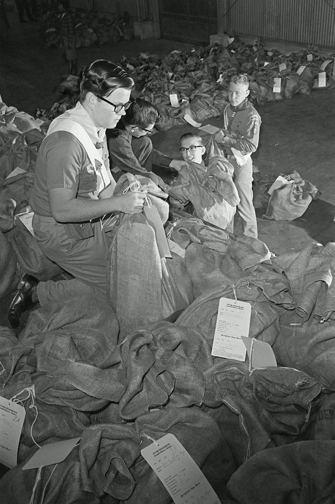 Dec. 24, 1965: Boy Scouts turned Santa’s helpers in readying a sea of sacks that Goodfellows filled for needy children. Among the helpers were Scouts Billy Carver, Explorer Larry Hyink, Explorer Billy Wilson and Scout Tommy Teter, left to right. Fort Worth Star-Telegram/UT Arlington Special Collections