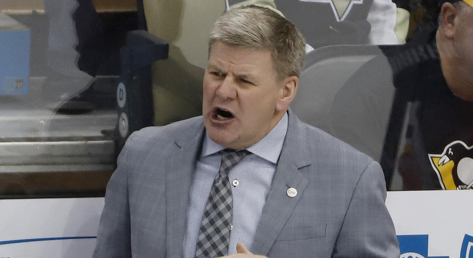 Calgary Flames head coach Bill Peters gives instructions during the first period of an NHL hockey game against the Pittsburgh Penguins in Pittsburgh, Saturday, Feb. 16, 2019. The Flames won 5-4. (AP Photo/Gene J. Puskar)