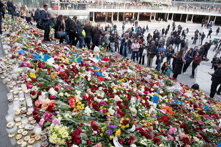 People leave flowers on the steps at Sergels Torg following the terror attack in central Stockholm, Sweden April 9, 2017. TT News Agency/Jessica Gow via REUTERS