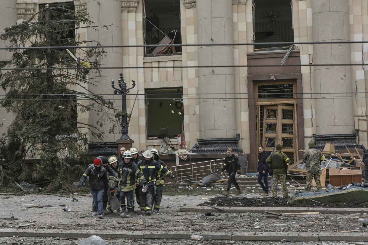 Ukrainian emergency service personnel carry the body of a victim following shelling of the City Hall building in Kharkiv, Ukraine, Tuesday, March 1, 2022. Russia on Tuesday stepped up shelling of Kharkiv, Ukraine's second-largest city, pounding civilian targets there. Casualties mounted and reports emerged that more than 70 Ukrainian soldiers were killed after Russian artillery recently hit a military base in Okhtyrka, a city between Kharkiv and Kyiv, the capital.