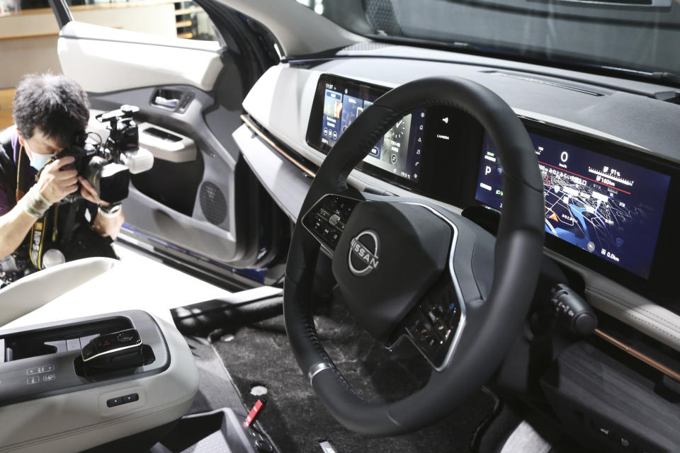 A photographer takes a photo of interior of Nissan Motor Co.'s new electric crossover Ariya at Nissan Pavilion in Yokohama near Tokyo Tuesday, July 14, 2020. The Ariya is the Japanese automaker’s first major all-new model since getting embroiled in the scandal surrounding former Chairman Carlos Ghosn.(AP Photo/Koji Sasahara)