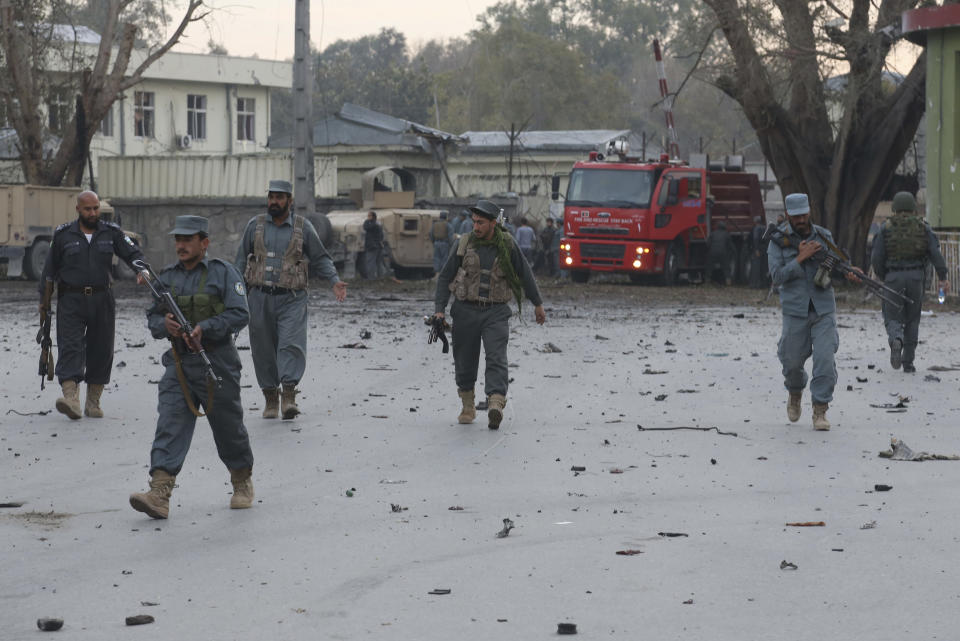 Afghan army and police gather around the area after an attack on a police station in Jalalabad, the capital of eastern Nangarhar province, Afghanistan, Thursday, March 20, 2014. Taliban insurgents staged a multi-pronged attack on the police station, using a suicide bomber and gunmen to lay siege to the station, government officials said. Two remotely detonated bombs also exploded nearby. (AP Photo/Rahmat Gul)