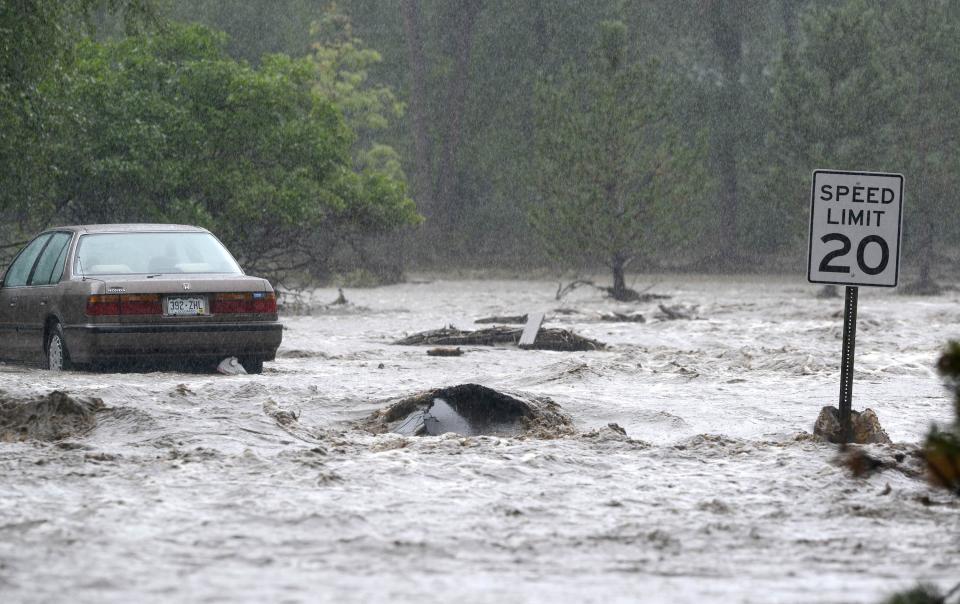 Water runs freely down Topaz Drive as heavy rains cause severe flooding in Boulder Colorado