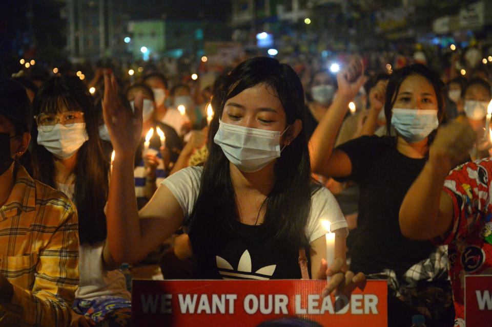 Protesters attend a candlelight night rally in Yangon, Myanmar, Saturday, Mar. 13, 2021. Security forces in Myanmar on Saturday again met protests against last month's military takeover with lethal force, killing at least four people by shooting live ammunition at demonstrators. (AP Photo)