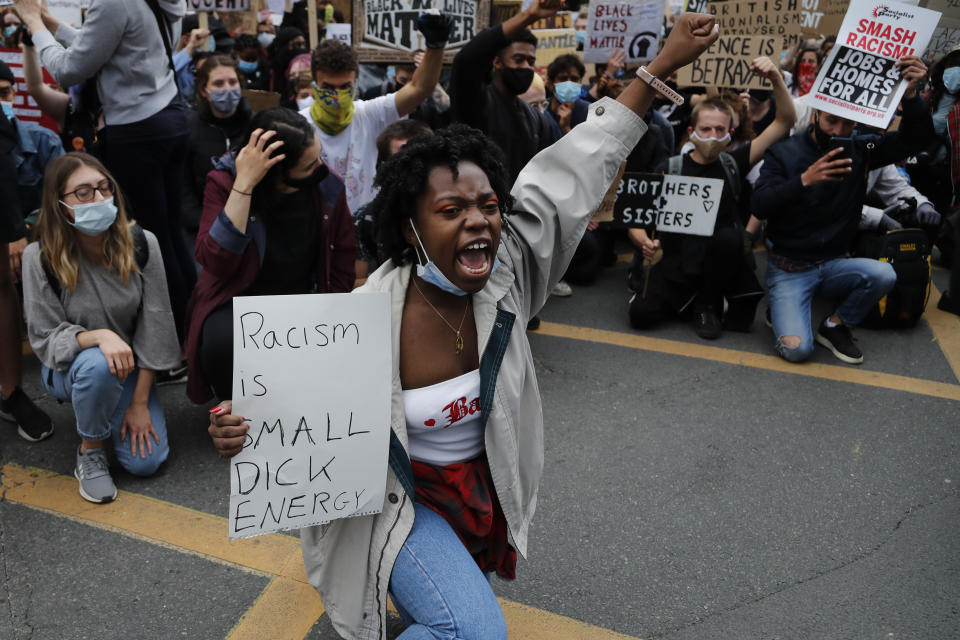 Protesters chant slogans in front of the US embassy, during the Black Lives Matter protest rally in London, Sunday, June 7, 2020, in response to the recent killing of George Floyd by police officers in Minneapolis, USA, that has led to protests in many countries and across the US. (AP Photo/Frank Augstein)