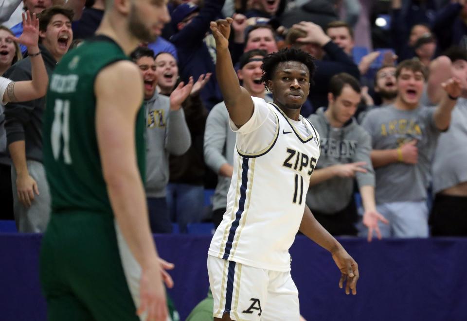 Akron Zips forward Sammy Hunter celebrates after knocking down a first-half 3-pointer against Ohio, Tuesday, Jan. 23, 2024.