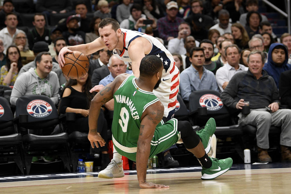 Boston Celtics guard Brad Wanamaker (9) was charged for a foul against Washington Wizards guard Garrison Mathews, back, during the first half of an NBA basketball game, Monday, Jan. 6, 2020, in Washington. (AP Photo/Nick Wass)