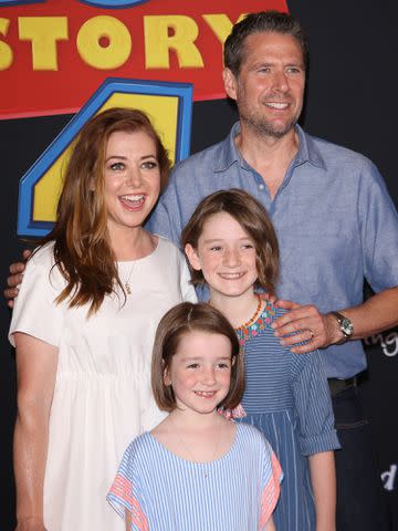 <p>Michael Tran/FilmMagic</p> Alyson Hannigan and Alexis Denisof with their kids, Satyana and Keeva, at a red carpet event in June 2019.