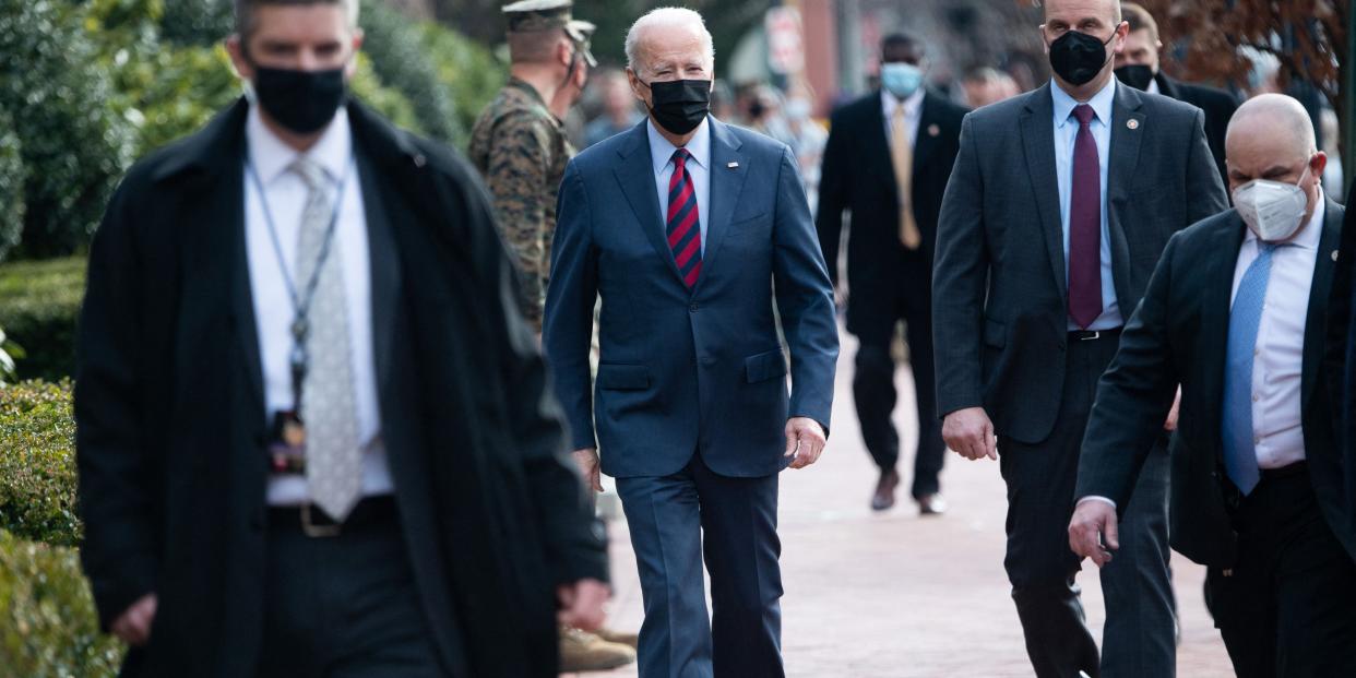President Joe Biden surrounded by US Secret Service members