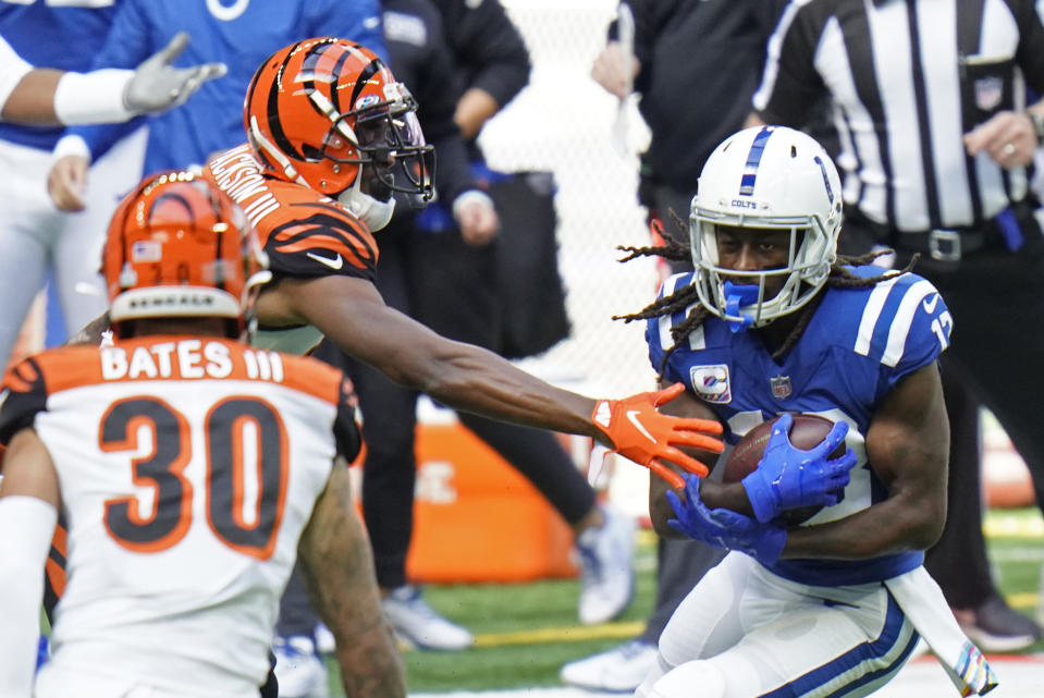 Indianapolis Colts' T.Y. Hilton (13) is tackled by Cincinnati Bengals' William Jackson (22) and Jessie Bates (30) during the first half of an NFL football game, Sunday, Oct. 18, 2020, in Indianapolis. (AP Photo/AJ Mast)