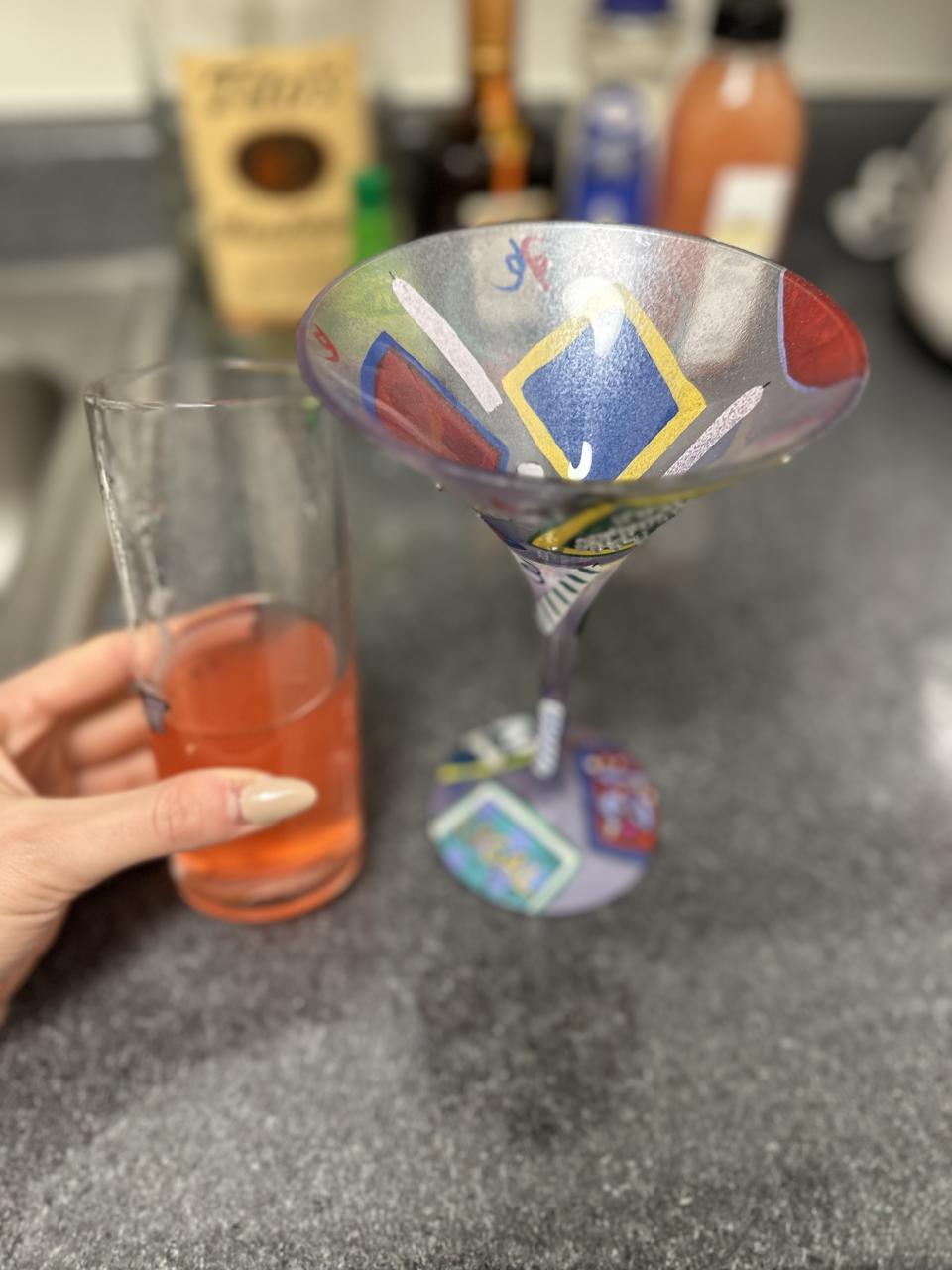 a glass of the drink next to a martini glass