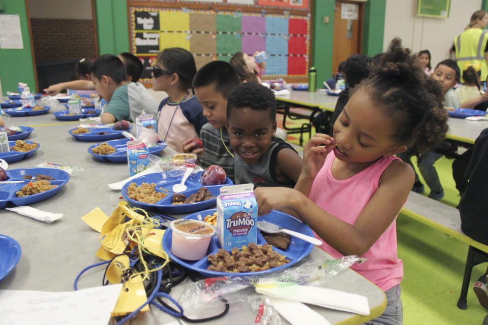 Students eating lunch in the cafeteria at Lowell Elementary School in Albuquerque, New Mexico, Aug. 22, 2023. Several states are making school breakfasts and lunches permanently free to all students starting this academic year, regardless of family income, and congressional supporters of universal school meals have launched a fresh attempt to extend free meals for all kids nationwide. (AP Photo/Susan Montoya Bryan)