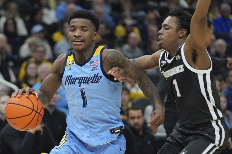 Marquette's Kam Jones is fouled by Providence's Jayden Pierre during the first half of an NCAA college basketball game Wednesday, Feb. 28, 2024, in Milwaukee. (AP Photo/Morry Gash)