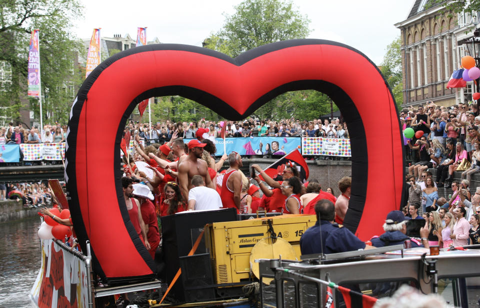 People take part in the Amsterdam Pride Parade, in Amsterdam, Netherlands, Saturday, Aug. 3, 2019. Tens of thousands of spectators are lining one of Amsterdam’s main canals to watch a flotilla of decorated boats make their way through the historic waterway as part of the Dutch capital’s nine-day pride festival. (AP Photo/Michael Corder)