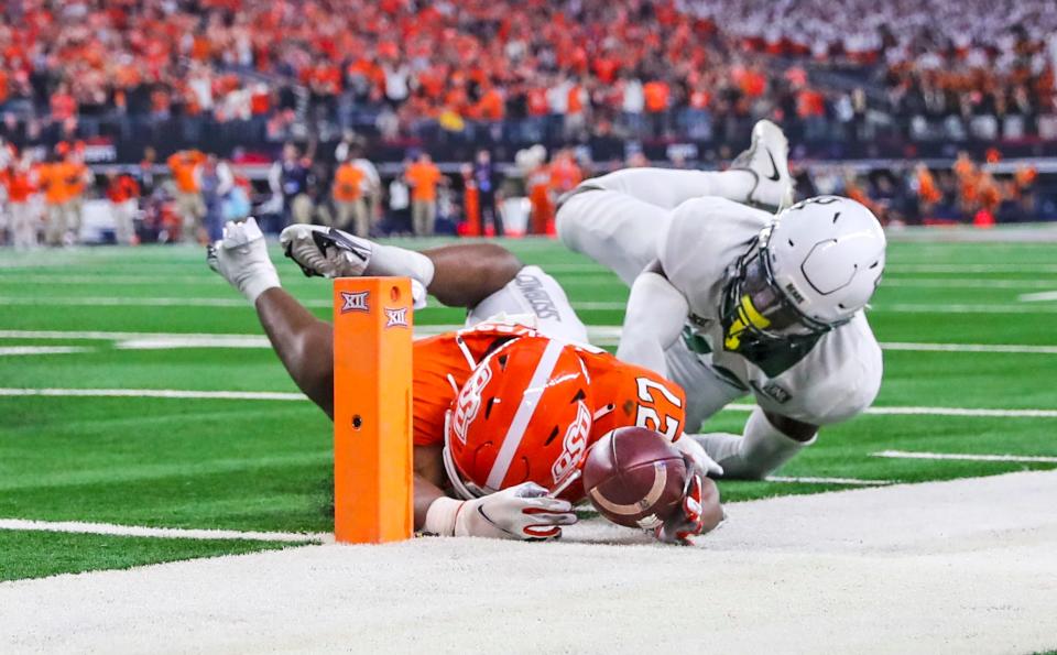 Dec 4, 2021; Arlington, TX, USA; Baylor Bears safety Jairon McVea (42) stops Oklahoma State Cowboys running back Dezmon Jackson (27) from scoring a touchdown during the fourth quarter of the Big 12 Conference championship game at AT&T Stadium. Mandatory Credit: Kevin Jairaj-USA TODAY Sports ORG XMIT: IMAGN-476744 ORIG FILE ID:  20211204_krj_aj6_0030.JPG