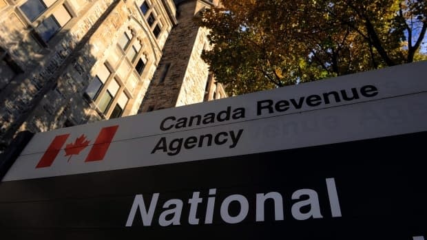 Police say one of the accused claimed to be from the Canada Revenue Agency on the phone and told the woman to hand over $10,000 or she'd be arrested. (CBC - image credit)