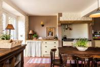 <p>A cupboard skirt is an ideal decorative finishing touch for rustic, country-style kitchens.</p><p>'Instantly softening, a sink skirt is also a great way to inject colour and pattern into your kitchen or pantry,' says Karla Patterson, Designer at British Standard. 'Affordable and stylish, it's also a clever way to conceal any unsightly storage and undersink spaces.'</p><p>Pictured: <a href="https://britishstandardcupboards.co.uk/" rel="nofollow noopener" target="_blank" data-ylk="slk:British Standard kitchen;elm:context_link;itc:0;sec:content-canvas" class="link ">British Standard kitchen</a> in the home of Lisa Mehydene, founder of <a href="https://edit58.com/" rel="nofollow noopener" target="_blank" data-ylk="slk:edit58;elm:context_link;itc:0;sec:content-canvas" class="link ">edit58</a>, British Standard by Plain English</p>