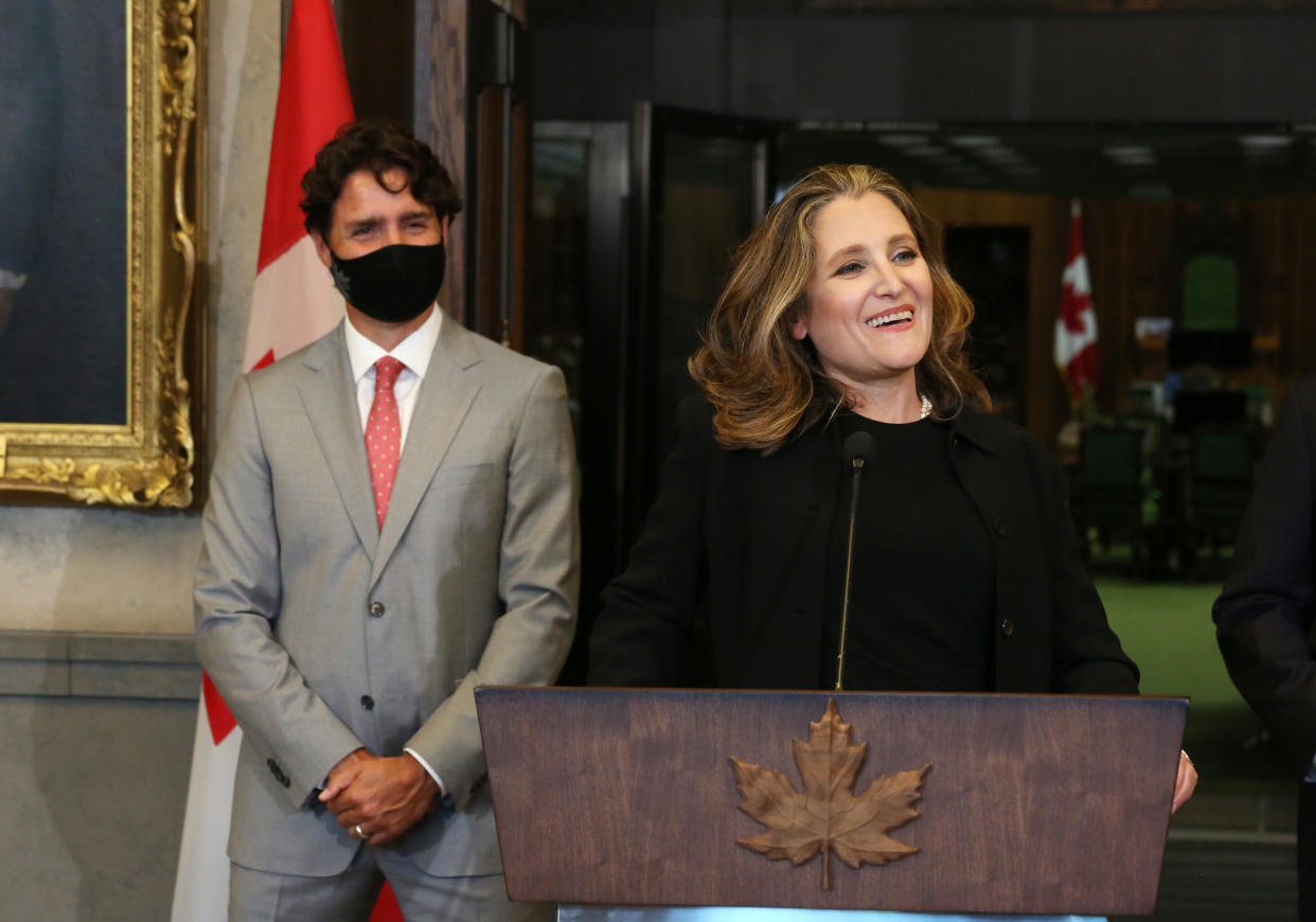 Canada's Deputy Prime Minister/Finance Minister Chrystia Freeland (R) speaks during a news conference on Parliament Hill August 18, 2020 in Ottawa, Canada, as Prime Minister Justin Trudeau looks. - Prime Minister Justin Trudeau tapped Chrystia Freeland to be Canada's first female finance minister on Tuesday as an ethics scandal that clipped her predecessor's wings reverberates through the government. Freeland received a standing ovation after being sworn in at a small ceremony at Rideau Hall, the official residence of Governor General Julie Payette in Ottawa. (Photo by Dave Chan / AFP) (Photo by DAVE CHAN/AFP via Getty Images)