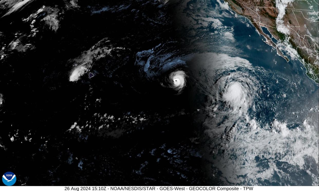 A satellite image of three storms in the ocean.