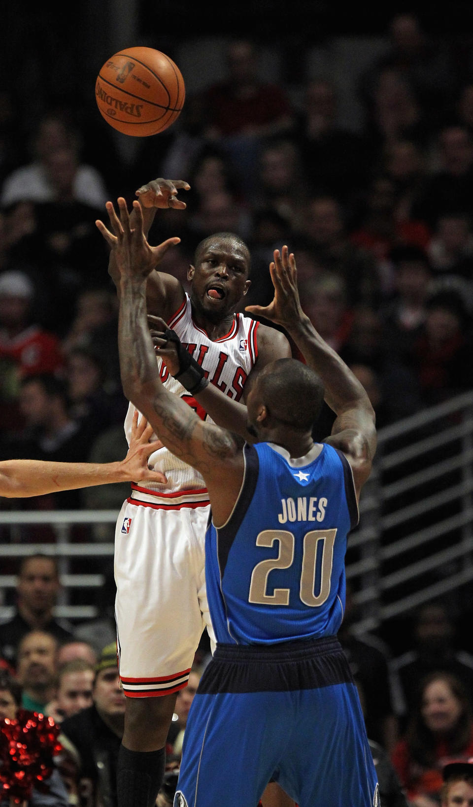 CHICAGO, IL - APRIL 21: Loul Deng #9 of the Chicago Bulls passes over Dominique James #20 of the Dallas Mavericks at the United Center on April 21, 2012 in Chicago, Illinois. NOTE TO USER: User expressly acknowledges and agress that, by downloading and/or using this photograph, User is consenting to the terms and conditions of the Getty Images License Agreement. (Photo by Jonathan Daniel/Getty Images)