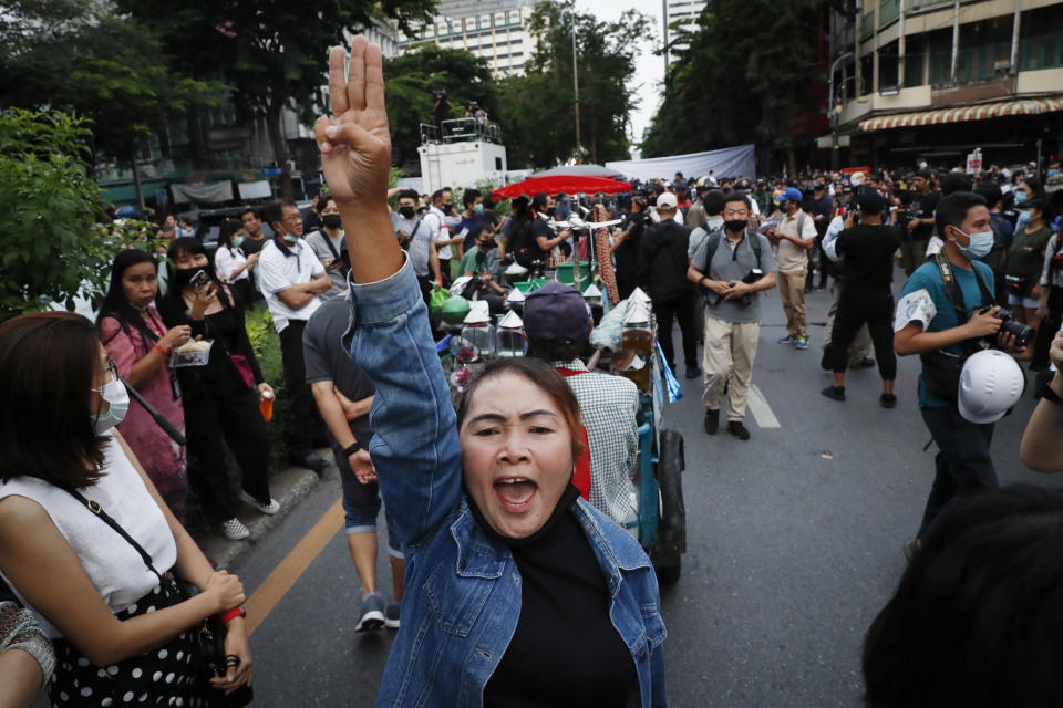 Pro-democracy demonstrators flash a three-finger salute of defiance during a protest rally in the Silom business district of Bangkok, Thailand, Thursday, Oct. 29, 2020. The protesters continue to gather Thursday with their three main demands of Prime Minister Prayuth Chan-ocha's resignation, changes to a constitution that was drafted under military rule and reforms to the constitutional monarchy. (AP Photo/Gemunu Amarasinghe)