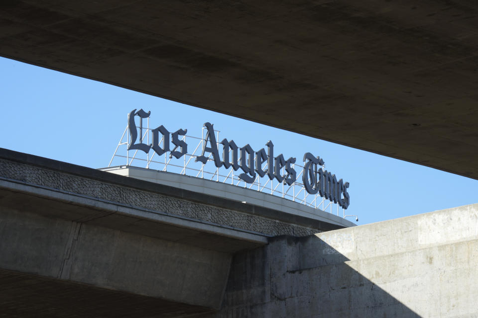 The Los Angeles Times newspaper logo is seen at their headquarters located in El Segundo, Calif., Tuesday, Jan. 23, 2024. The Los Angeles Times plans to lay off 94 newsroom employees starting Tuesday, according to the head of the journalists' union who said the number, while substantial, is less than feared. (AP Photo/Damian Dovarganes)