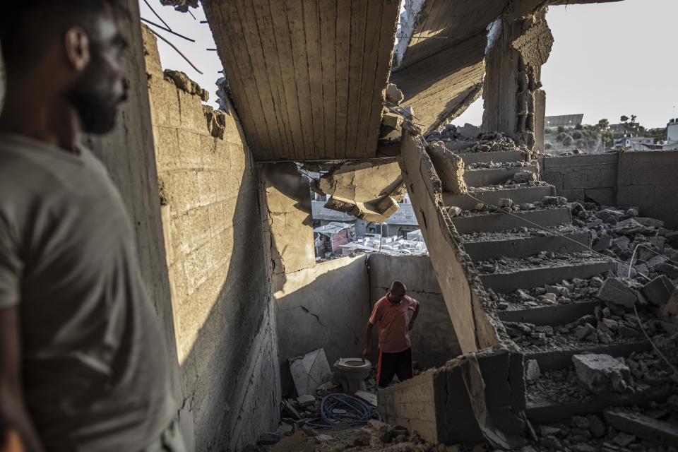 FILE - Palestinians inspect their house after it was hit by an Israeli airstrike in Gaza City, Sunday, Aug 7, 2022. (AP Photo/Fatima Shbair, File)