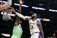 Los Angeles Lakers' LeBron James (23) dunks against Minnesota Timberwolves' Gorgui Dieng (5) during the first half of an NBA basketball game, Sunday, Dec. 8, 2019, in Los Angeles. (AP Photo/Ringo H.W. Chiu)